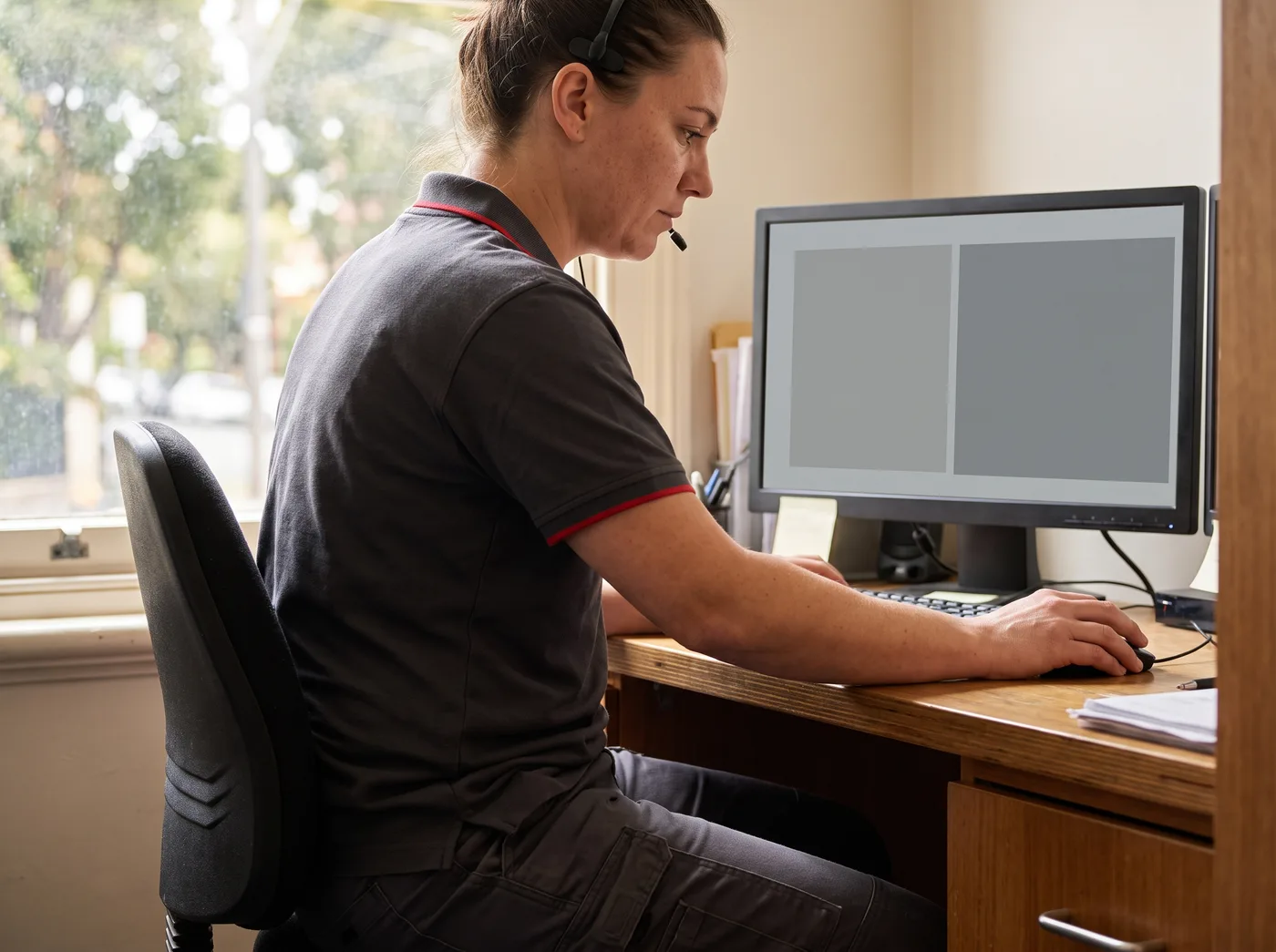 Service coordinator taking a booking call in a Melbourne office