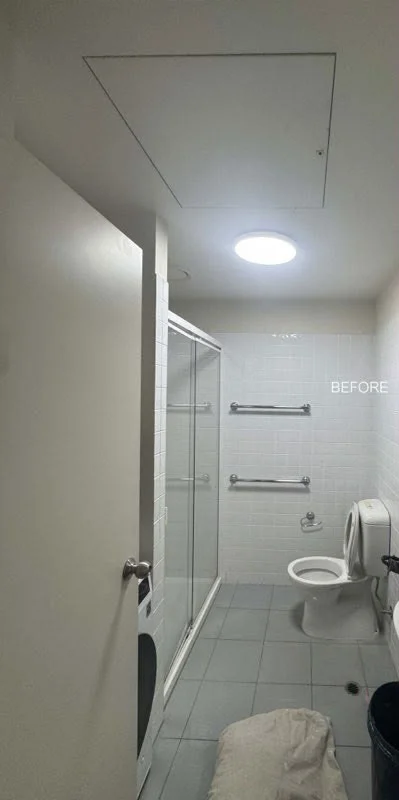Accessible bathroom with plain white walls, ceiling and door before repainting