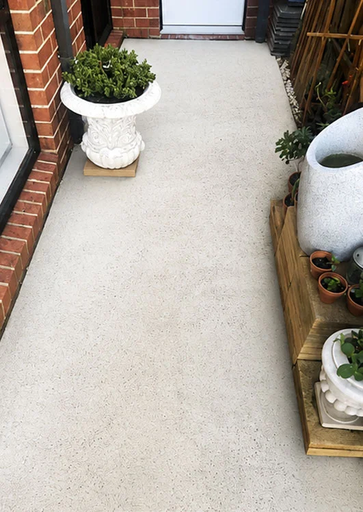 Same concrete path pressure cleaned back to a bright, even finish for the end of lease