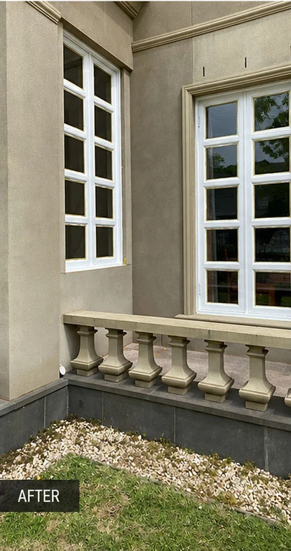 Exterior window frames freshly painted crisp white against the rendered wall and balustrade