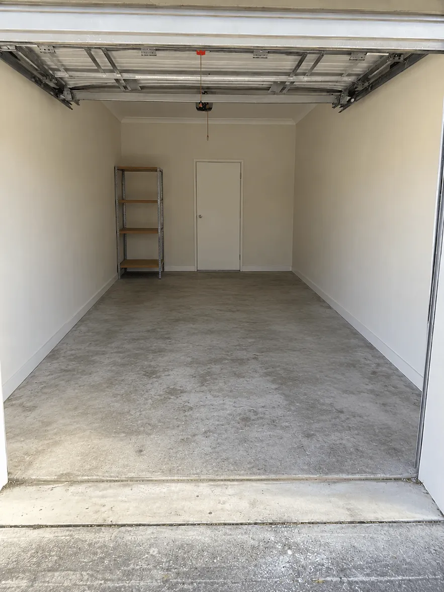 Same garage emptied and swept clean after a hard rubbish clear-out