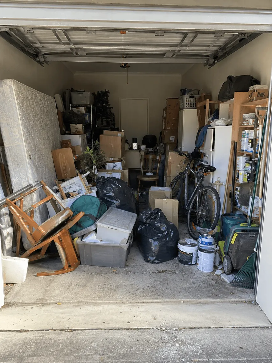 Suburban Melbourne garage packed with boxes, old furniture and junk before a clear-out