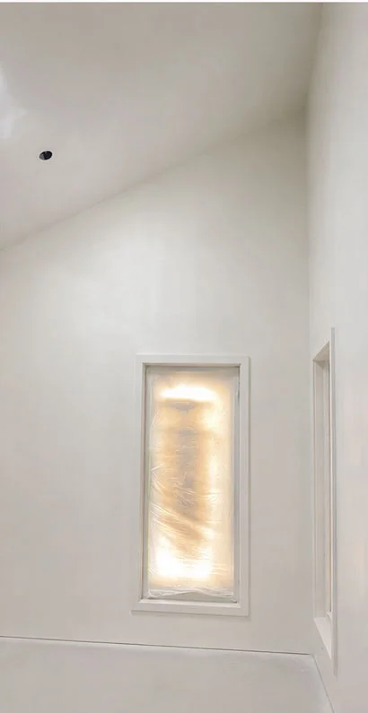 Smooth finished white walls and raked ceiling after interior painting