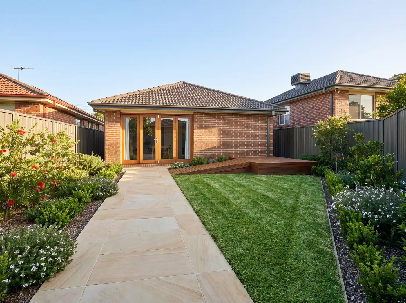 A tidy accessible garden path and lawn at a Melbourne home after maintenance